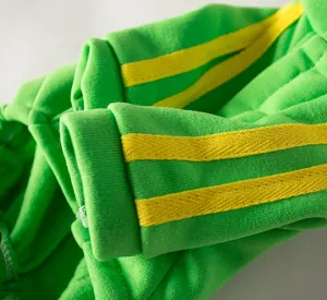 Detail view of green pet sweatshirt sleeve with yellow triple stripes