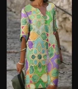 Close-up detail showing the vibrant vintage abstract geometric print on the V-neck dress.