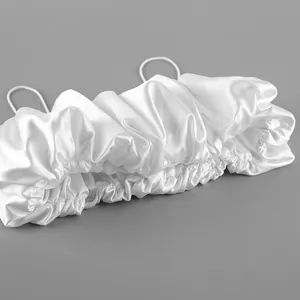 Detail of white satin cropped camisole featuring ruffled texture and thin spaghetti straps