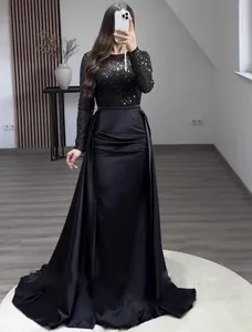 Elegant black long-sleeve sequin evening gown with a flowing satin mermaid train