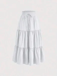 Detail showing the white tiered maxi skirt's ruffled layers and fabric texture.