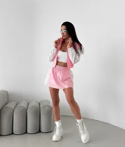 Close-up of pink and white color-block tracksuit set with zip-up jacket and mini skirt