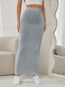 Detail view of a stylish grey ribbed knit maxi skirt with an elastic high waist