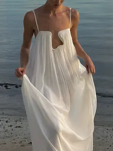 Elegant white backless slip maxi dress for beach vacation featuring unique U-neckline