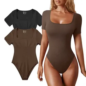 Detail view of women's ribbed short sleeve yoga bodysuit in black and brown colors