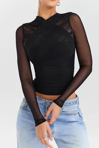 Detail view of a black sheer mesh long-sleeved top with elegant ruched cross design.