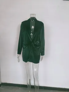 Detailed texture of the dark green velvet fabric on a professional mannequin display