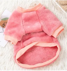 Close-up detail of soft pink coral fleece dog sweater with ribbed cuffs and collar.