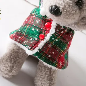Close-up of Christmas snowflake plaid pet cloak with fuzzy trim and red buttons