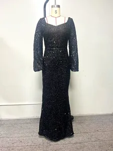Elegant black sequined long-sleeved evening gown on a mannequin for formal occasions