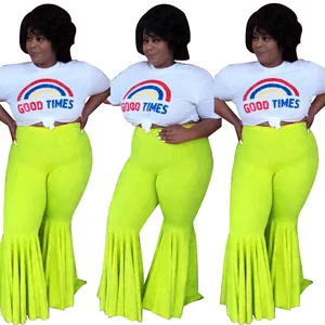 Vibrant neon green high-waisted ruffle hem flare pants with rainbow graphic t-shirt.