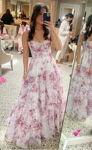 Elegant pink floral organza maxi evening dress with tiered skirt and corset bodice detail.