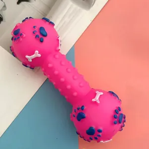 Detail view of pink squeaky dog toy dumbbell with blue paw prints and bone patterns