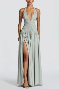 Elegant sage green deep V-neck halter evening gown with a high side slit and ruched waist.
