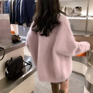 Back view of a cozy pink faux mink fur cardigan in a loose, oversized autumn fit.