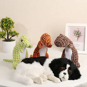 Tre colorati giocattoli sonori per cani a forma di dinosauro in velluto di mais.