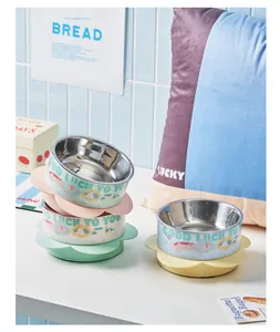 Cute stainless steel pet food bowls with decorative flower bases in a lifestyle scene