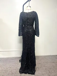 Elegant black sequined evening gown featuring flared sleeves and a floor-length silhouette.