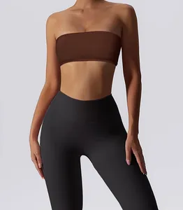 Close-up view of a brown strapless bandeau sports bra paired with black yoga leggings