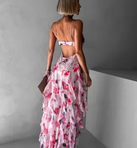 Backless view of elegant chiffon maxi dress with pink floral ruffles and straps.