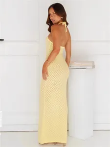 Elegant backless yellow knitted halter neck maxi dress perfect for beach vacation styling