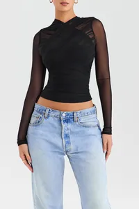 Detail shot of black ruched mesh long-sleeve top with elegant sheer texture