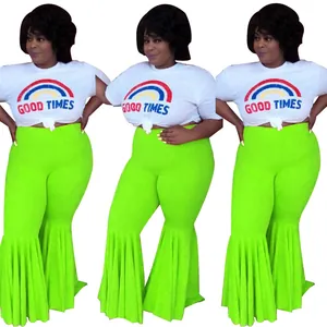 Women's sexy neon green flared trousers with pleated ruffle hem and white rainbow t-shirt