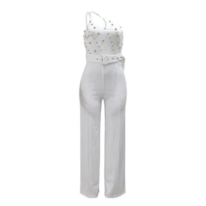 Elegant white one-shoulder jumpsuit featuring gold bead studs and matching waist belt