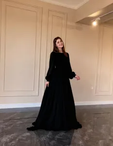 Elegant black long-sleeved chiffon maxi dress with flowing wide skirt and modest design