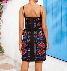Back view of a black floral print spaghetti strap dress with red and blue patterns.