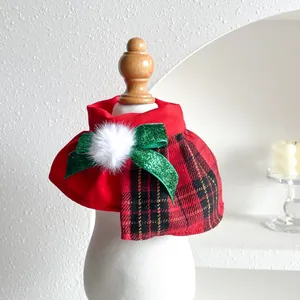 Detail view of red plaid Christmas pet collar with green bow on white mannequin