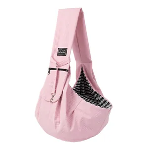 Pink quilted pet sling carrier with checkered lining and safety leash