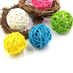 Close-up of colorful woven rattan balls designed for parrots and small pets to chew and play