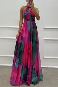 Full length view of vibrant floral print maxi dress featuring a halter neck and flowing skirt
