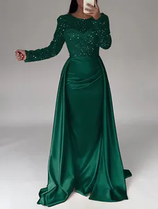 Detailed view of the dark green sequin bodice and elegant satin skirt of this evening gown