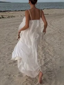 Elegant white spaghetti strap backless maxi dress for beach vacation and summer resorts