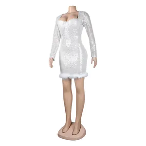 Detailed view of a white sequined long sleeve mini dress with feather hem trim