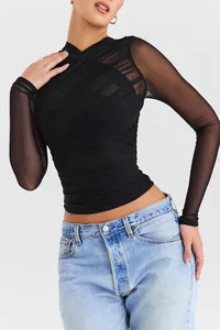 Detail view of black long sleeve sheer mesh top with elegant ruched V-neck design.