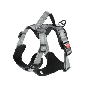 Detail view of a grey reflective dog harness vest featuring a safety buckle and handle