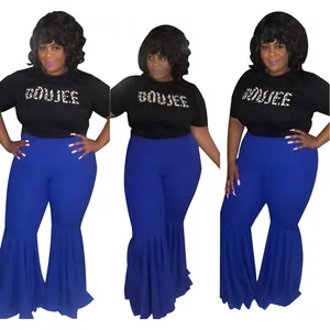 Detailed view of women's blue high-waist flared pants with ruffle hem and black tee
