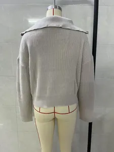 Back detail of a retro loose knit sweater in beige featuring a wide polo collar