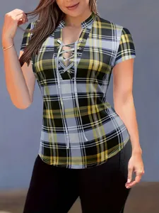 Close-up of yellow plaid print slim fit top featuring front lace-up and stand collar