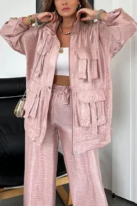 Detail view of pink metallic utility jacket with large pockets and wide-leg trousers