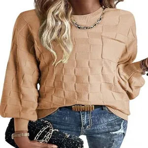 Detailed close-up view of women's beige checkered knit sweater featuring a round neck