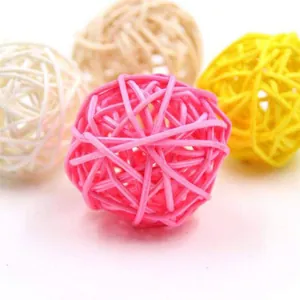 Macro detail of colorful woven rattan balls for parrot chewing and pet foot toys