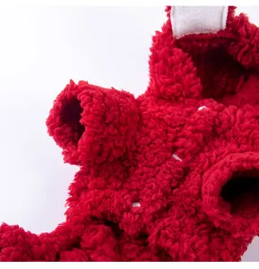 Detailed macro view of the soft red fuzzy fleece material on a warm pet hoodie.