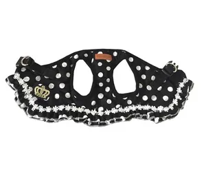 Detail view of a black polka dot pet harness with lace trim and gold crown emblem.