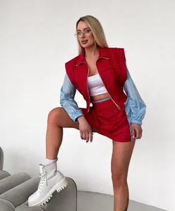 Full body view of a stylish women's red and light blue color-block jacket and skirt set