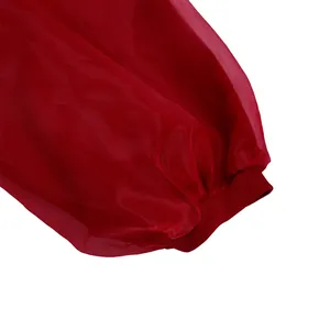 Close-up of red sheer mesh lantern sleeve with ribbed knit cuff for women's dress
