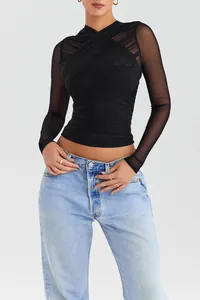 Detailed view of a black mesh long-sleeved top with elegant ruched cross-over design.